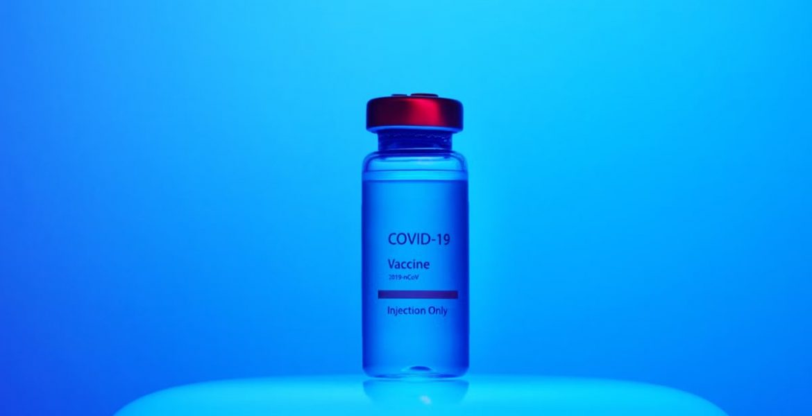 Vial of COVID-19 vaccine labeled for injection, set against a blue background.